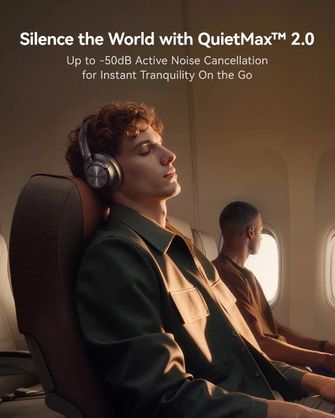 A man wearing QuietMax 2.0 over-ear headphones rests in an airplane seat, with another passenger visible in the background.