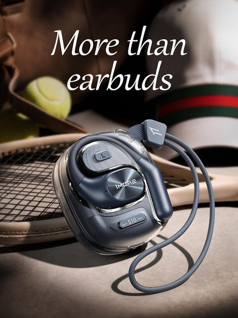 A dark gray and black wireless earbud with a matching cable and small logo, styled on a tennis court surface with a racket, tennis ball, and athletic shoe in the background. The text 'More than earbuds' is overlaid at the top.